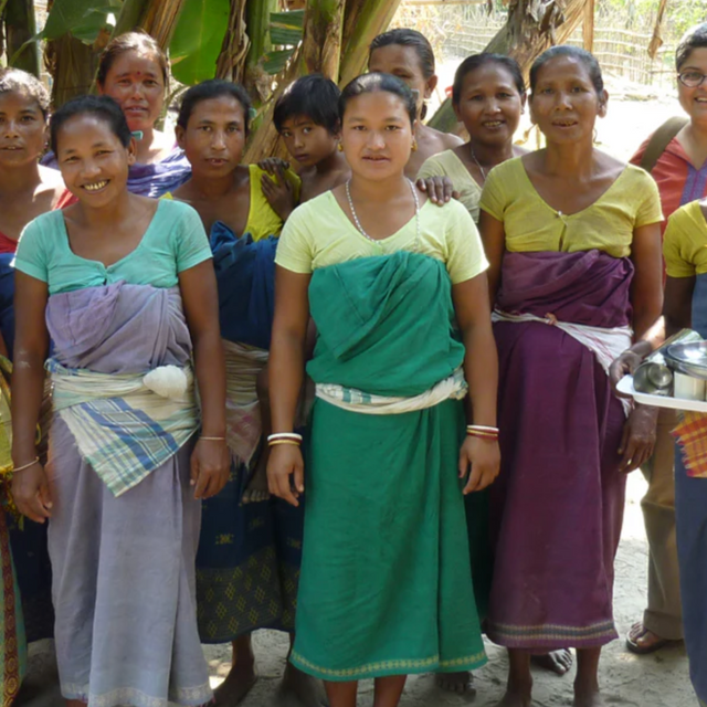 Sustainable Threads picture of workers smiling and standing in front of palm trees