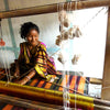 Indian Artisan smiling and weaving handwoven cotton napkins