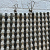 Stainless Steel pegs on green and white checked bath towel hanging on clothesline