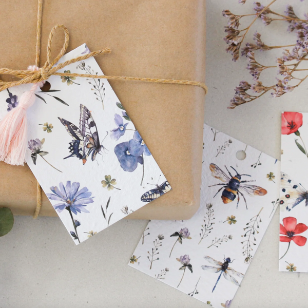 plantable gift tag that grows into daisies, butterflies, bees, flowers on wrapped gift