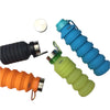 expandingtravel drink bottles flatlay with bottles laying down graphite, orange, lime green and sky blue