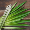 Photo of cut lemongrass leaves on wooden background