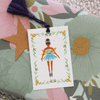 nutcracker plantable gift tags ballerina design on wrapped gift with floral wrapping paper