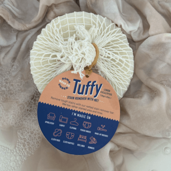 Tuffy Stain Remover Soap with Net covering in washing basin with fabric being washed