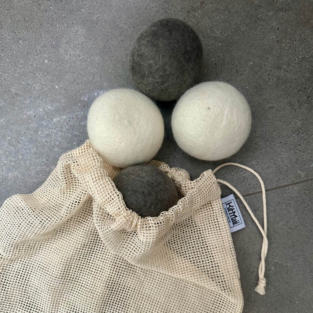 Photo of Wool Dryer Balls in organic cotton produce bag on grey tile
