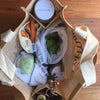 jute shopping bag with handy pockets filled with fruit and veggies in produce bags 