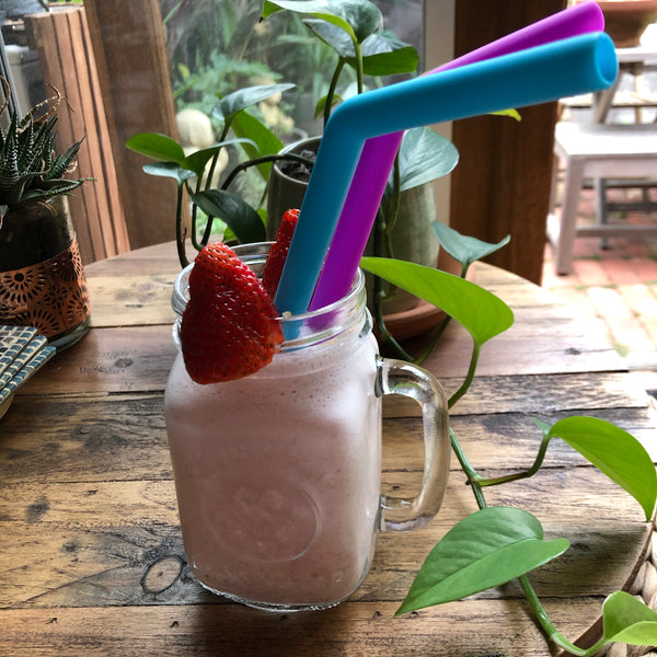 Reusable Silicone Straws in Strawberry Smoothie in glass jar on table