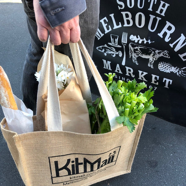 jute shopping bag with handy pockets filled with veggies, flowers and bread outside South Melbourne Market